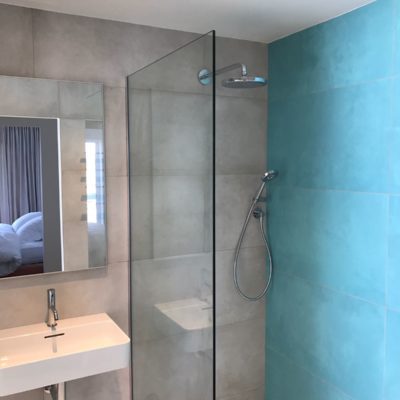 Turquoise feature tiled wall En-suite with large walk in shower