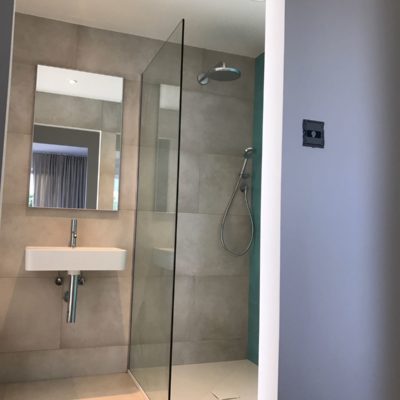 Turquoise feature tiled wall En-suite with large walk in shower
