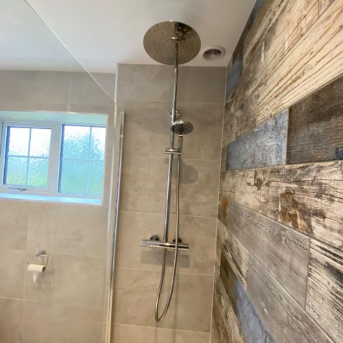 Large walk in shower with wood plank feature tiles