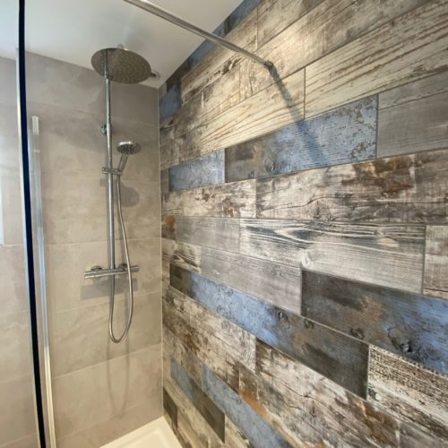Large walk in shower with wood plank feature tiles